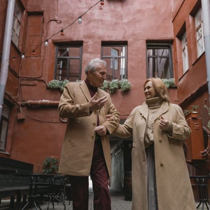An older couple laughing together outside